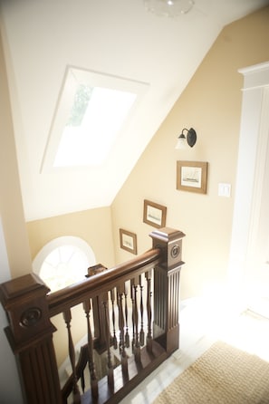 Salvaged and renovated staircase to upper bedrooms and Captains bed.