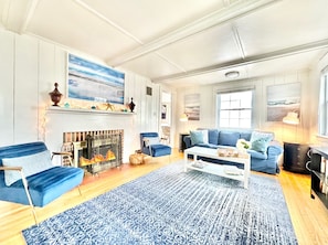 Charming, living room in the “Cottage” style. Lots of seating & wood-burning FPL