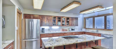 Kitchen - Beautifully upgraded space with granite counters, hardwood flooring, and stainless steel appliances.