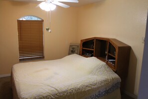 The master bedroom has a king size bed plenty of dressers and a walk in closet.