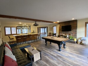Family room with wetbar, pool table, tv, sofa/sleeper convertible, hot tub room