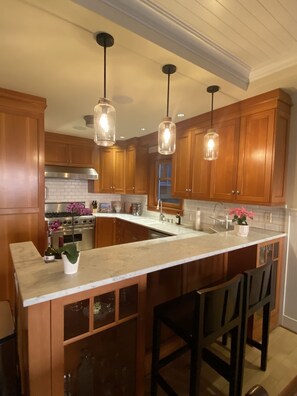 Kitchen features Marble countertops, Sub-Zero refrigerator, Viking stove.