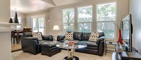 Cozy family room with gas fireplace and leather sofa seating