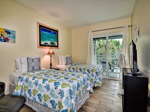 Guest room has queen and twin bed and balcony access.