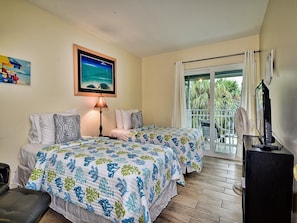 Guest room has queen and twin bed and balcony access.