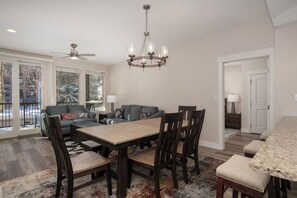 Living area, dining area, and kitchen all flow together nicely with the open floor plan.