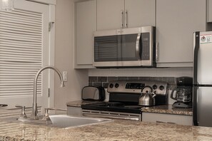 Kitchen with granite counter top and stainless steel appliances