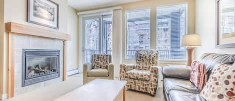 Living Area - Gas fireplace, access to the private balcony, and a queen size sofa sleeper.