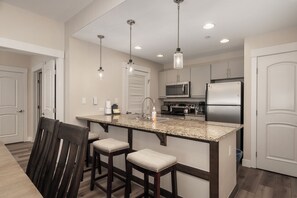 Dining table with seating for six guests. Additional seating at the counter.