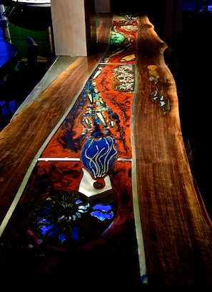 Walnut slab bar with imbedded fossils and hand poured pewter