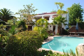 Sparkling blue, pool in a tropical garden; salt water - no chlorin
