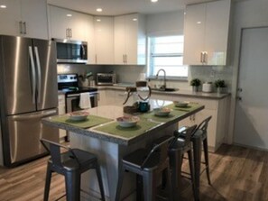 Front door and kitchen with island