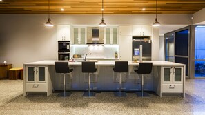 Create delicious meals in a well-equipped kitchen while chatting over the spacious island.