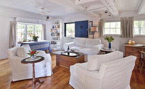 Living room with armchairs that swivel to face the couch or the flat screen HDTV