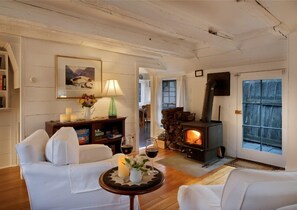 Relaxing by a fire in the wood-burning fire stove on a winter evening