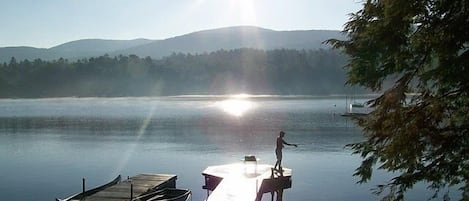 View of Dock area showing lakeside patio, swim and boat docks, steps into water