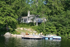 View of house from water showing swim and boat docks