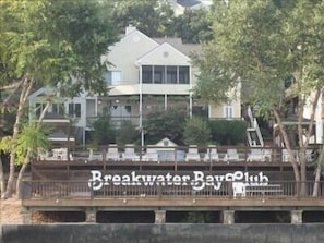 View from the water, of the pool area and picnic area below. 