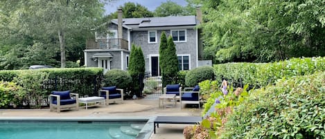 Relax in a private pool in a lush backyard