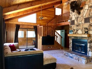 Large great room with beautiful stone fireplace perfect for entertaining!