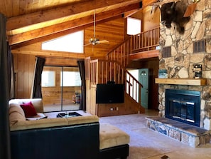 Large great room with beautiful stone fireplace perfect for entertaining!