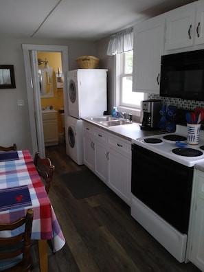 Eat in kitchen showing door to downstairs 3/4 bath