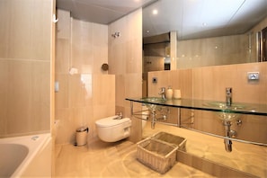 En-suite bathroom to the master bedroom with bath, shower, toilet, bidet and hand basin for two