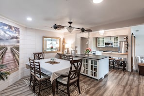 Open plan with kitchen with two islands, seven stools, large table