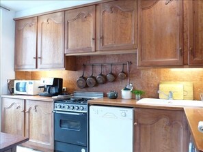 Spacious, fully equipped kitchen with Italian tile floors, marble back splash