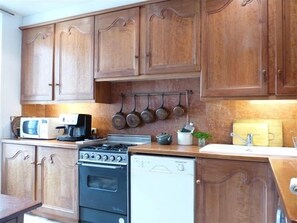 Spacious, fully equipped kitchen with Italian tile floors, marble back splash