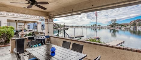 Open the living room doors to access the patio area with BBQ at River Front