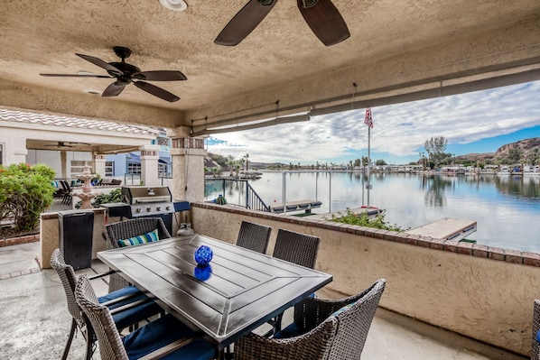Open the living room doors to access the patio area with BBQ at River Front