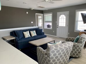 Comfy living room with brand new sofa leading out to upper balcony.