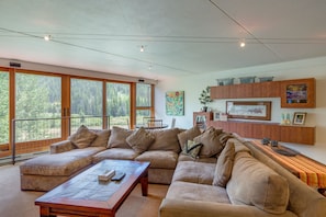 Main level Living room with large comfy sofa and windows facing beautiful mtns!