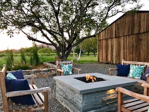 Sunset evenings in comfort at fire pit with view of barn & neighboring vineyards