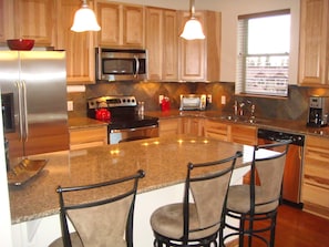 Full Kitchen With Large Counter & Chairs