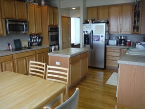 Kitchen with ample counter space, eating area, island, & breakfast bar