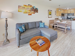 Sit back and enjoy this light filled and expansive living room with custom artwork throughout.