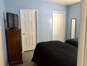 Sunny second bedroom with 2 twin beds, large closet & half bath.