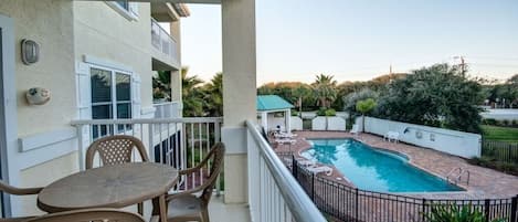 View of the pool from the large balcony, ocean in the distance beyon the trees!