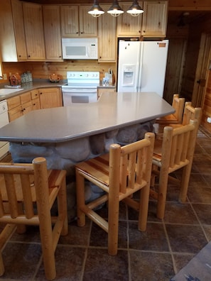 Large kitchen island with 5 log crafted chairs