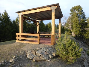 Hilltop gazebo overlooks four mountain ranges.