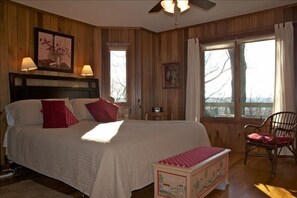The master bedroom has a California king bed and poplar paneling.