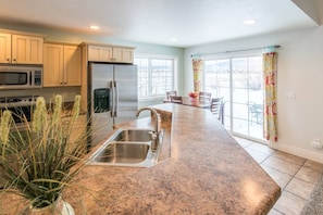 You'll love the gorgeous views from the tasteful, bright kitchen with plenty of space to prep meals and eat.