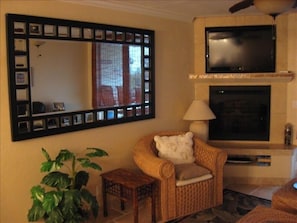 Our custom fireplace has an inset 44" HD flat screen TV with expanded cable.
