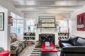 Living Room with remote controlled fireplace, flat screen with DVR & DVD player.