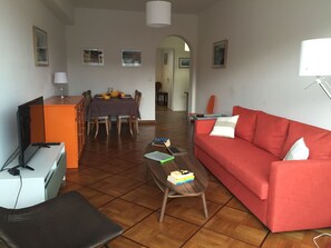 Large and comfortable living and dining area with a sofa bed