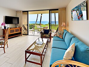 Living Room - Light and colorful entertainment area with the perfect view of the blue Pacific Ocean