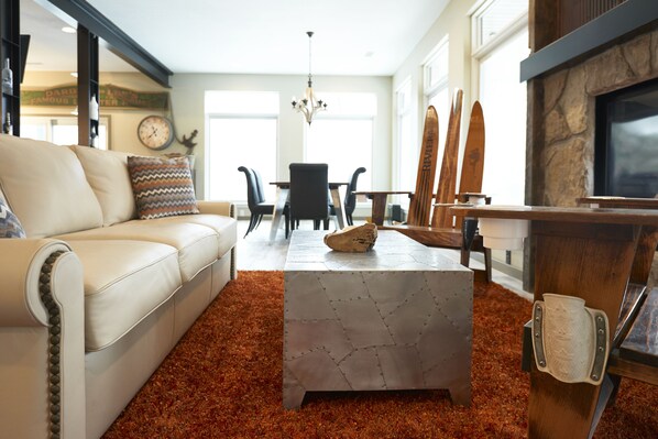 Lower level; outdoor view; fireplace ; family area.  Sofa is a King Size Bed!