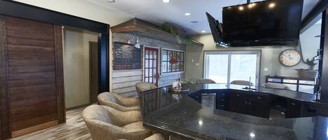 Lower level bar with barn slider to block off for privacy such as meetings, etc.